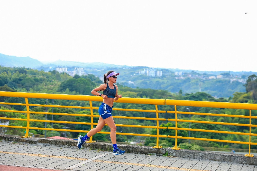 Runner training outdoors on a scenic bridge during a focused session