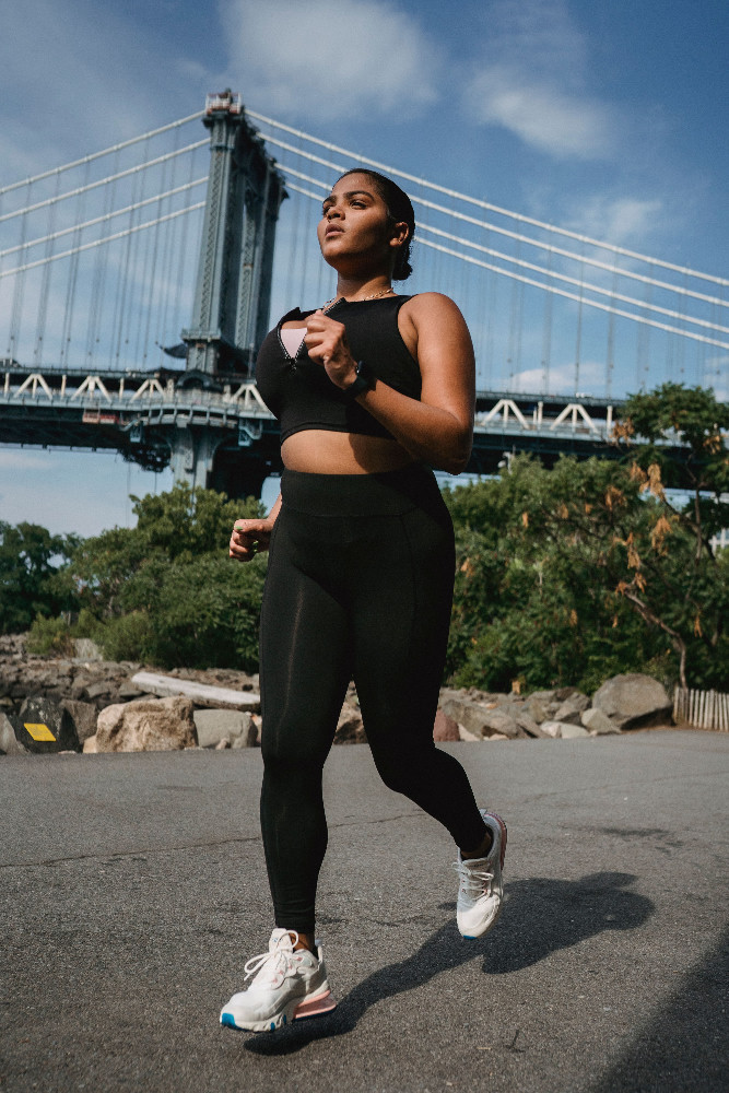 Runner training outdoors near an American bridge